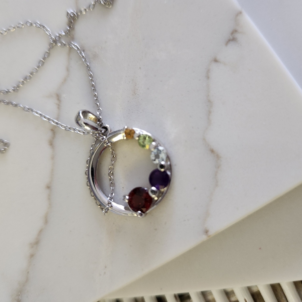925 Sterling silver round pendant with assorted semi precious gems.